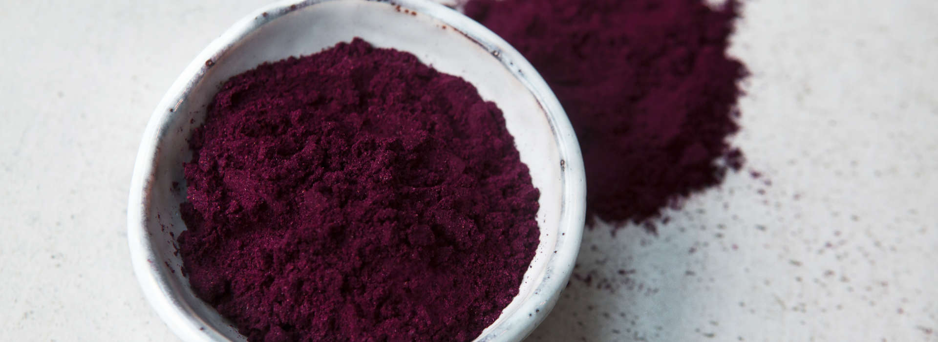 purple haskap berries powder in a bowl