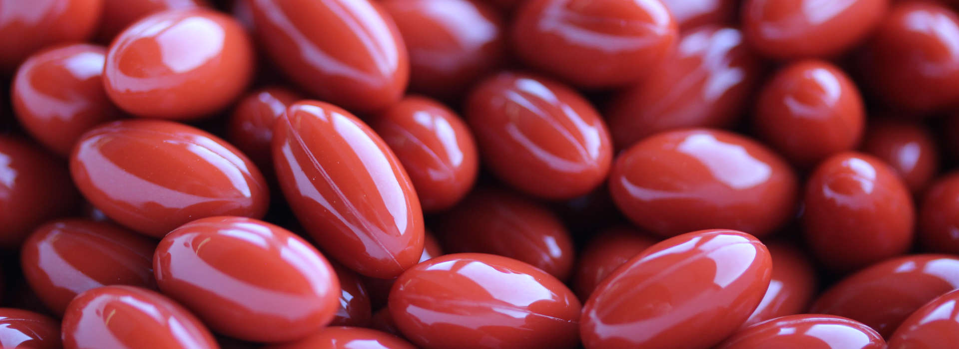 large quantities of red colored softgels 